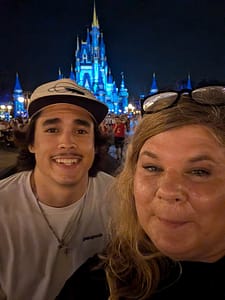 JB Roams travel bloggers in front of Magic Kingdom Castle at Walt Disney World Orlando