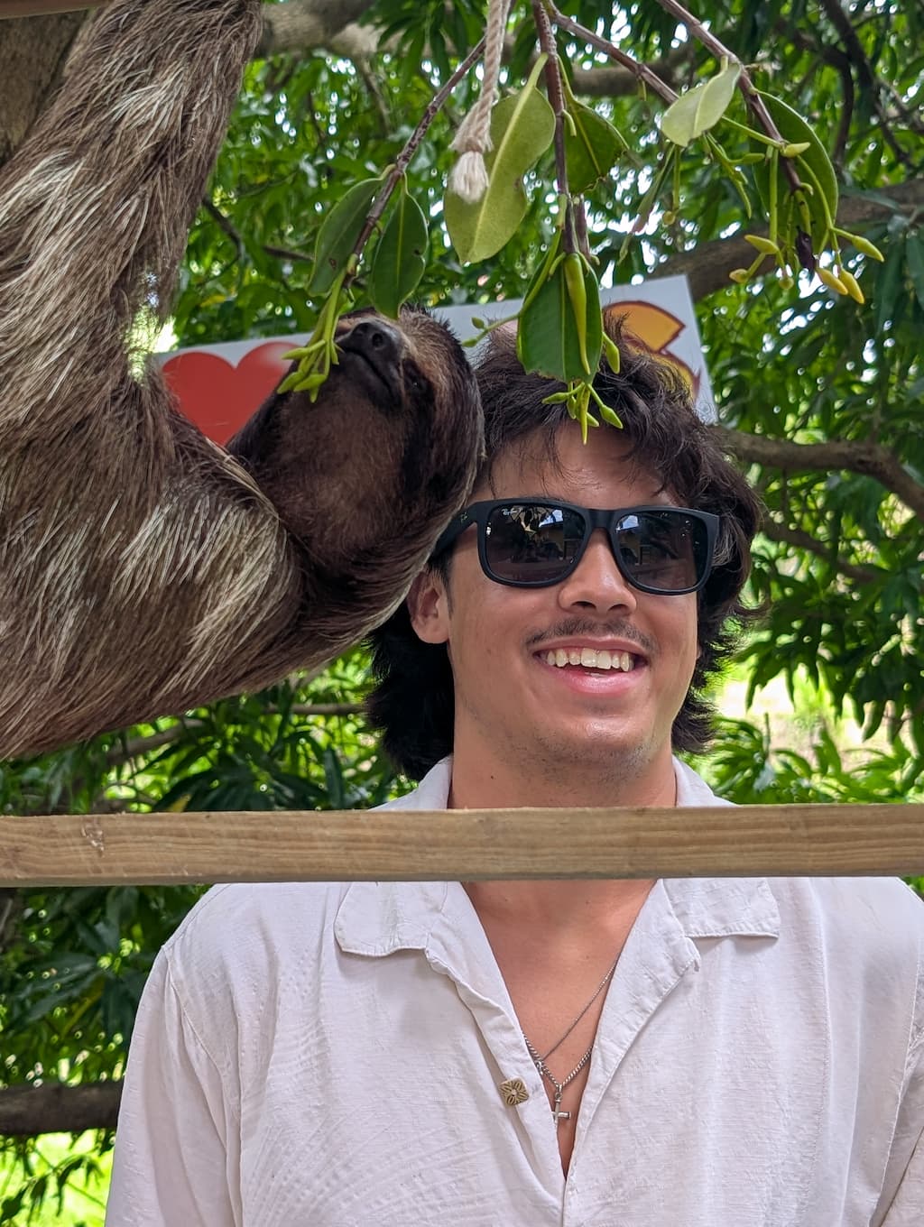 jude with sloth at AJ's sloths and monkeys in roatan