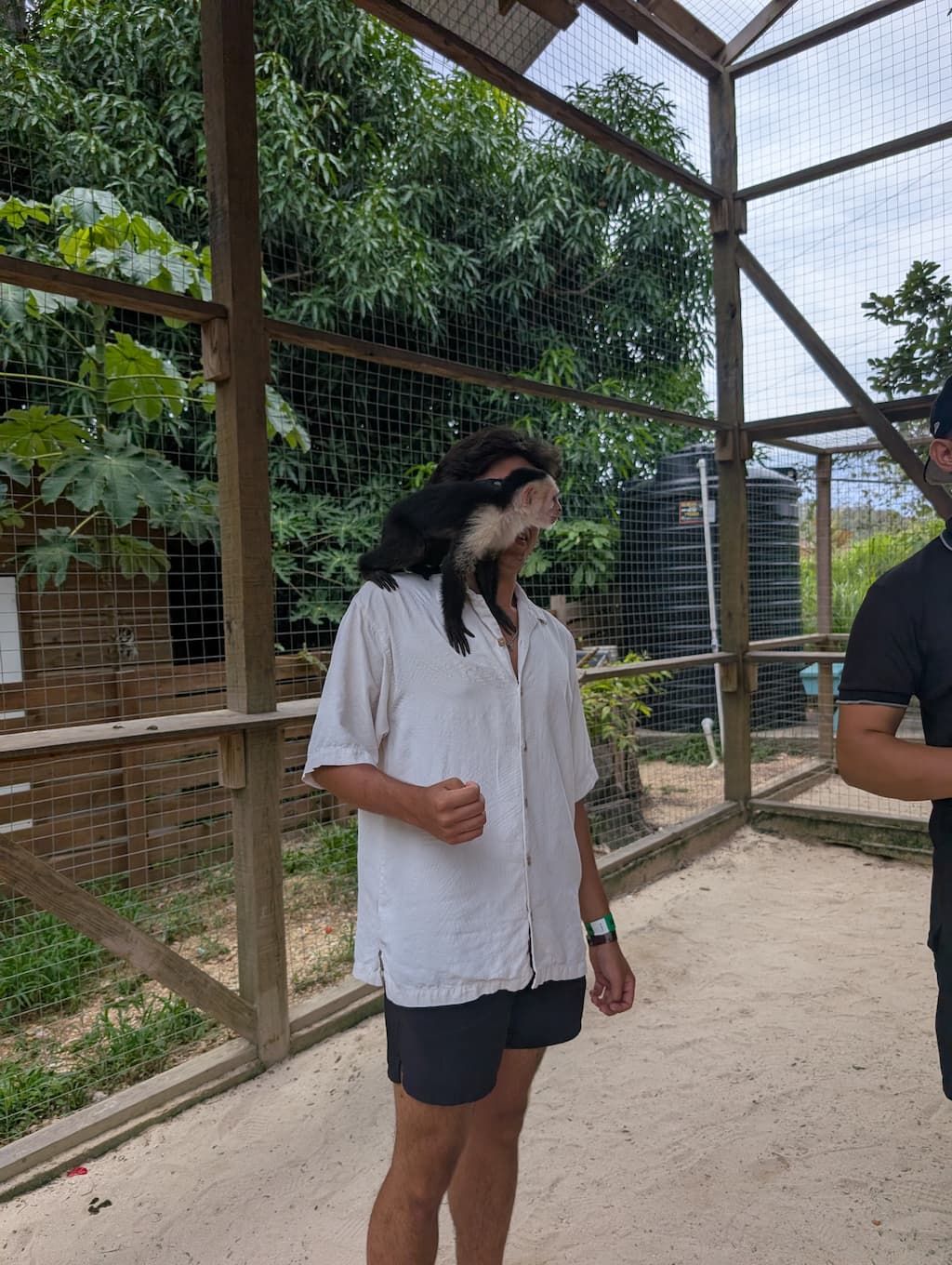 jude with a monkey at AJ's sloths and monkeys in roatan